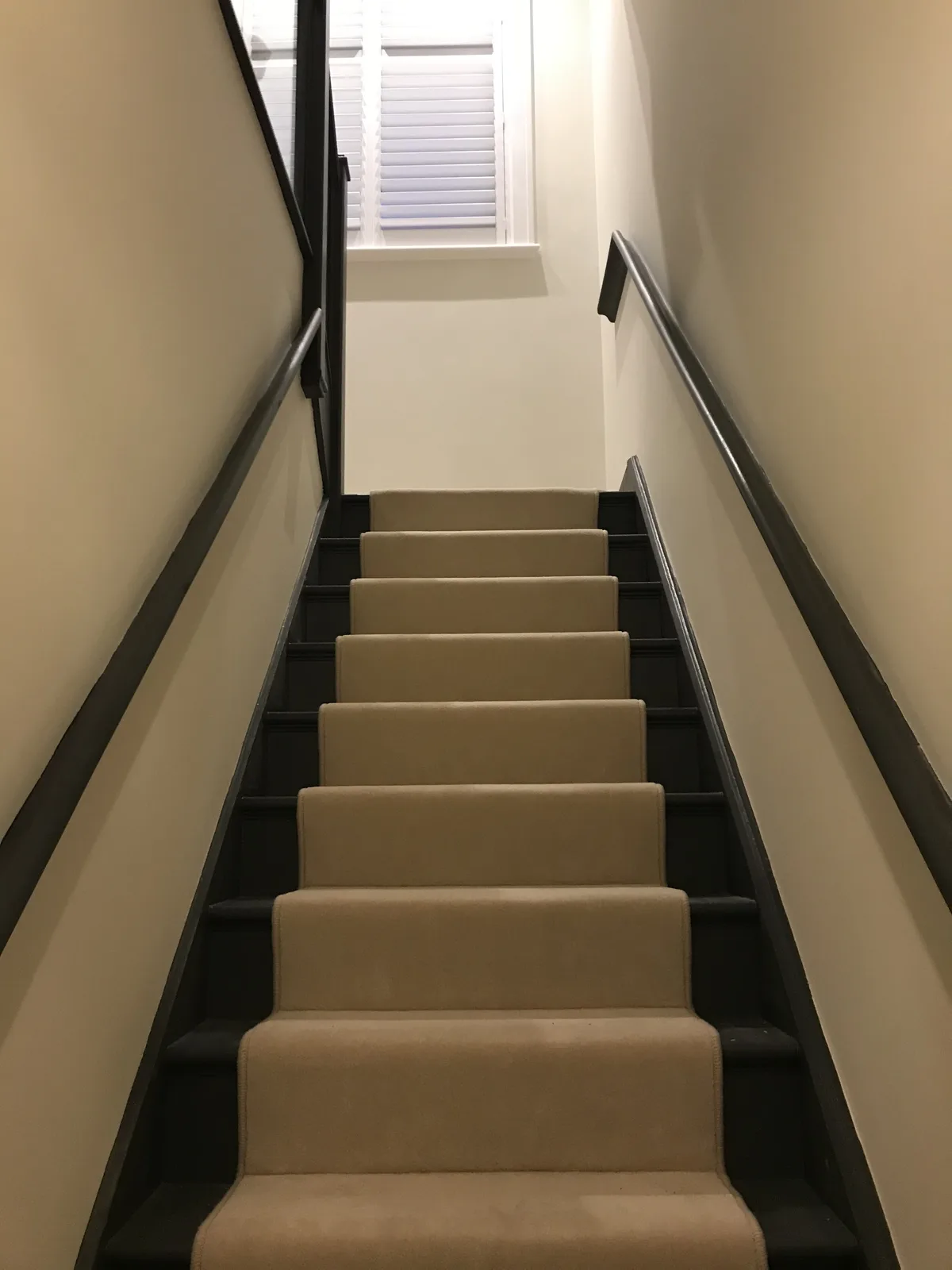 Finished loft staircase with carpet runner and painted balustrade in Essex